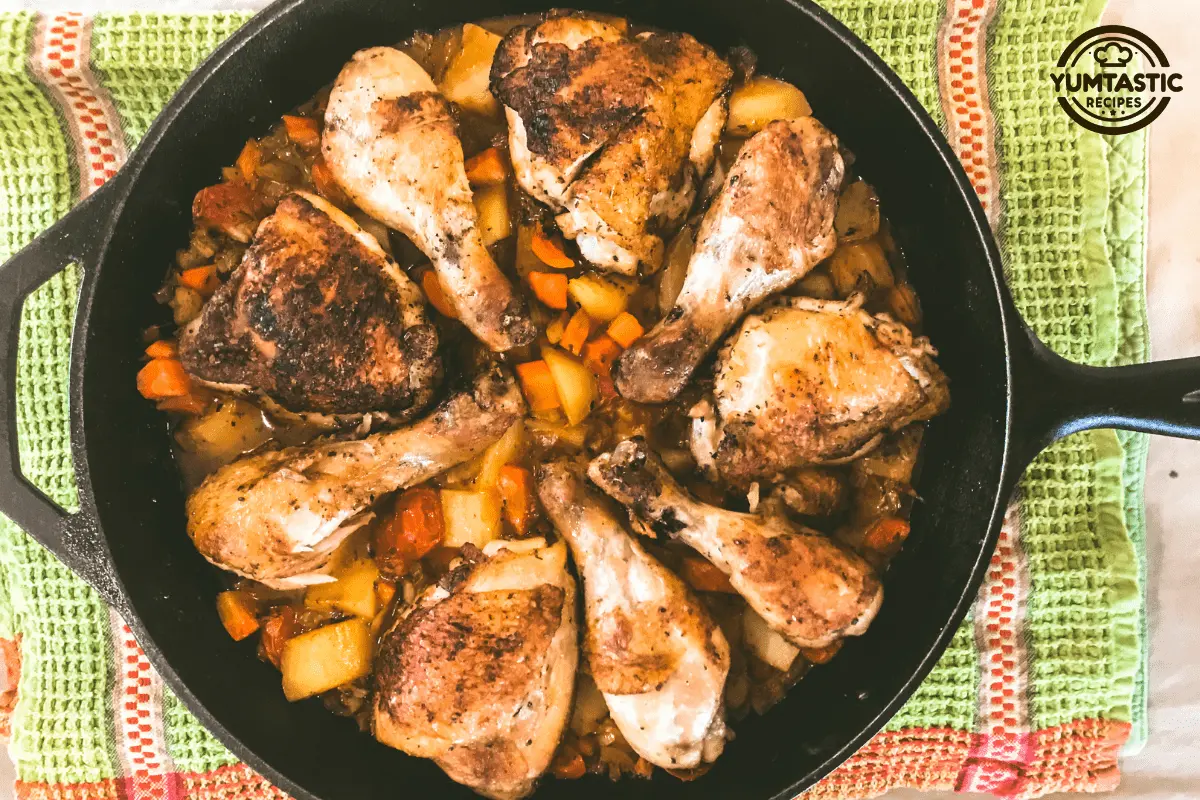 Chicken fricassee with vegetables in a black cast-iron skillet