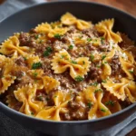 creamy parmesan garlic beef pasta in rustic bowl